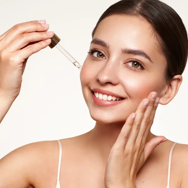Skincare model with a serum dropper